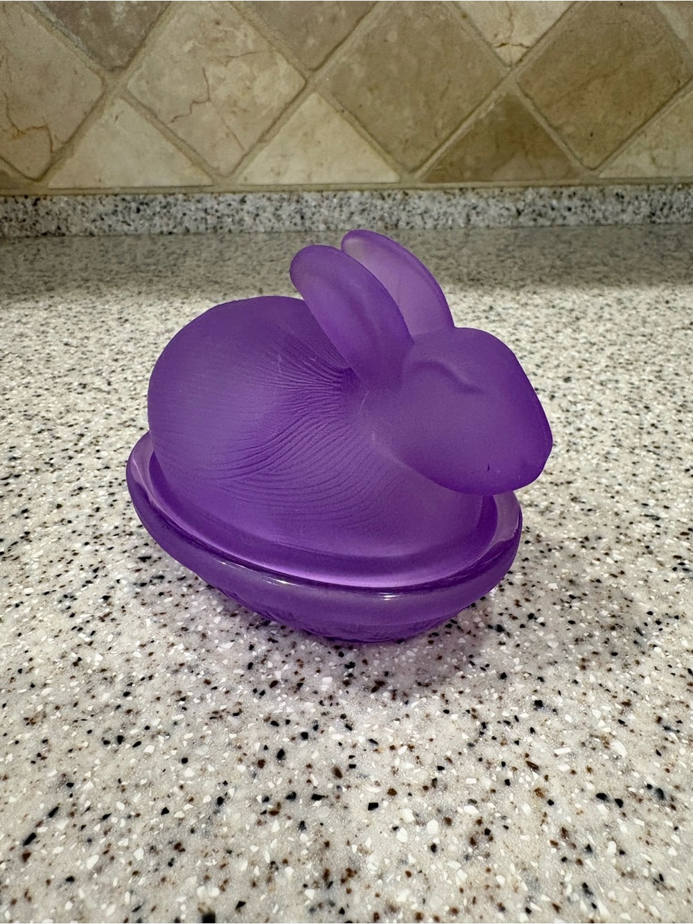 Purple frosted glass rabbit on a nest covered candy dish